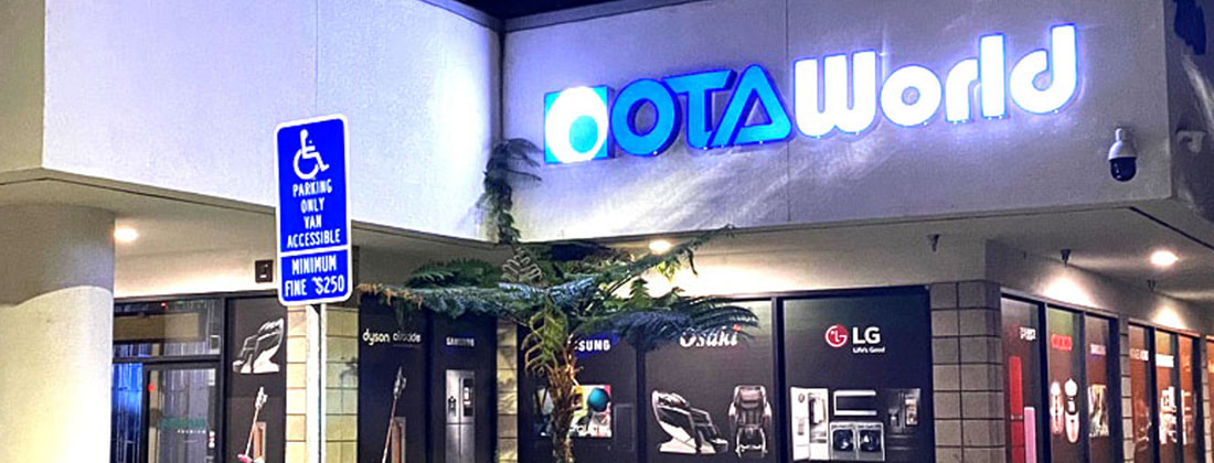 OTA World storefront at night
